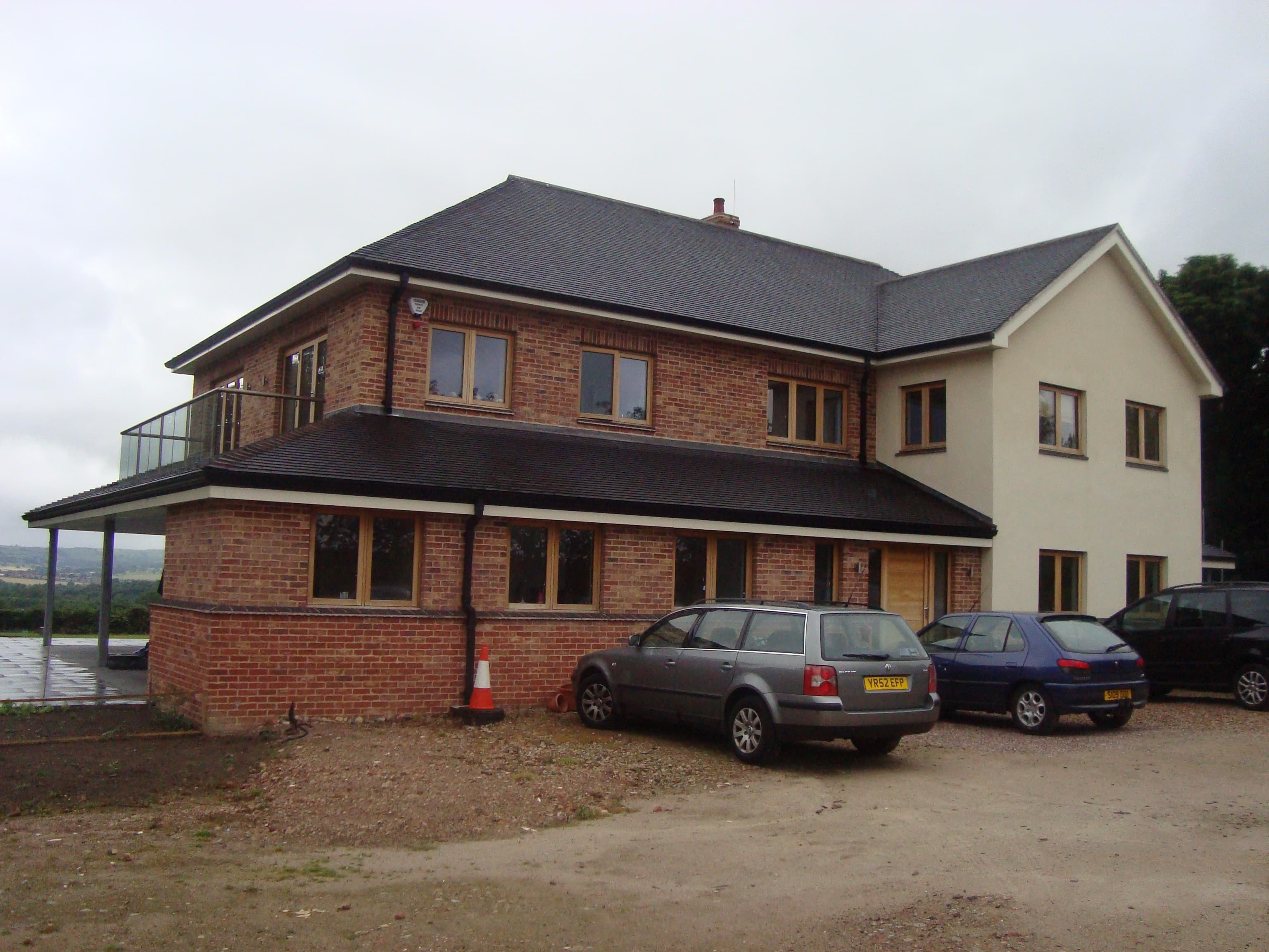 Rear and side elevation with driveway and parking area